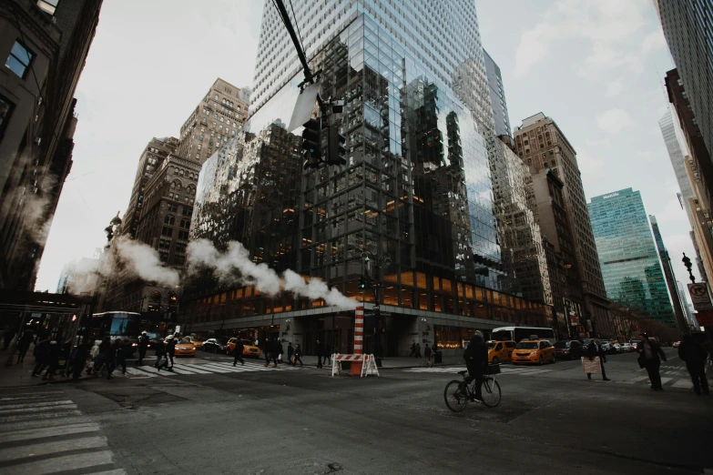 a group of people walking across a street next to tall buildings, by Adam Rex, pexels contest winner, tiny smokes from buildings, mies van der rohe, attacking nyc, thumbnail