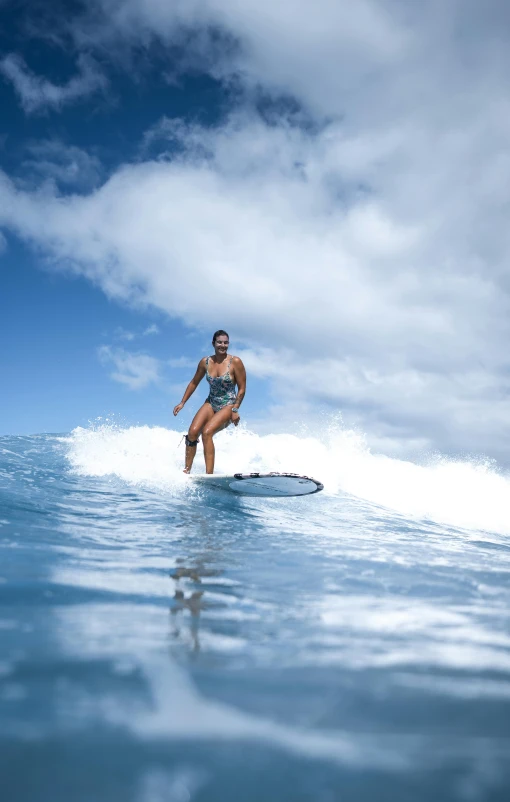 a woman riding a wave on top of a surfboard, profile image