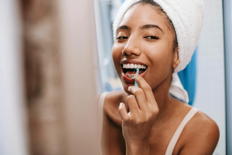 a woman brushing her teeth in front of a mirror, trending on pexels, underbite, avatar image, candy treatments, 1 2 9 7