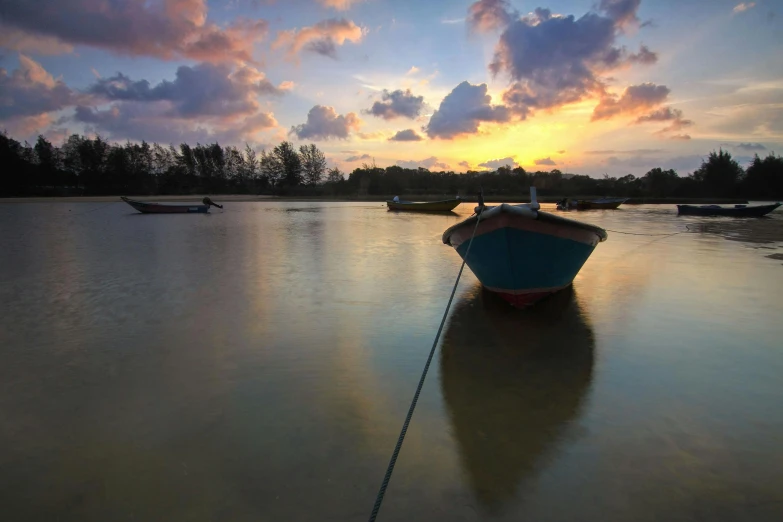 a boat sitting on top of a body of water, by Reuben Tam, pexels contest winner, serene colors, day setting, sri lankan landscape, glossy surface