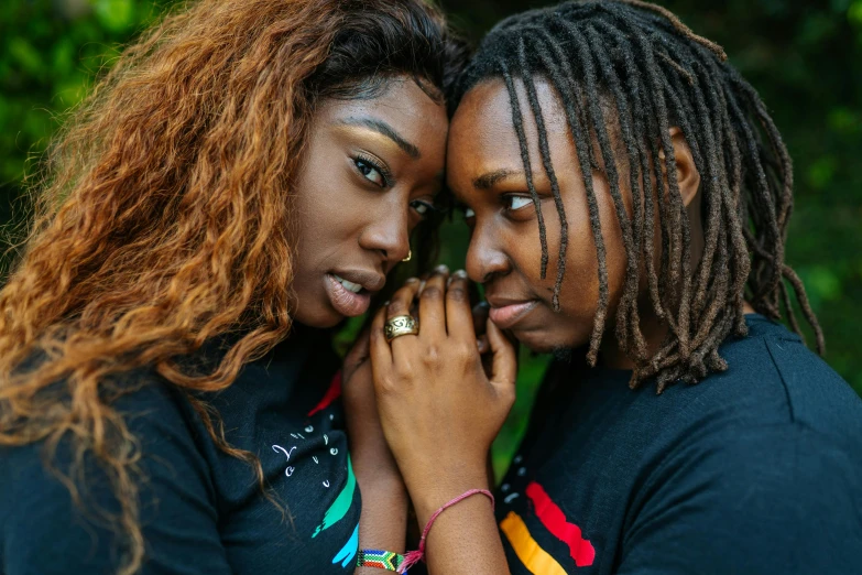 a couple of women standing next to each other, trending on pexels, renaissance, dreadlock hair, lgbt, hands, black