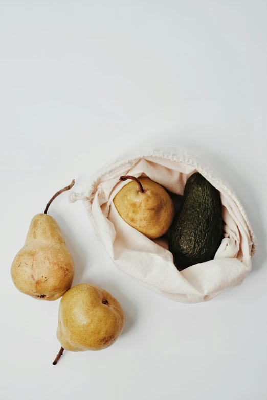 two pears, an avocado, and an avocado in a bag, a still life, unsplash, lined in cotton, beige, product view, small