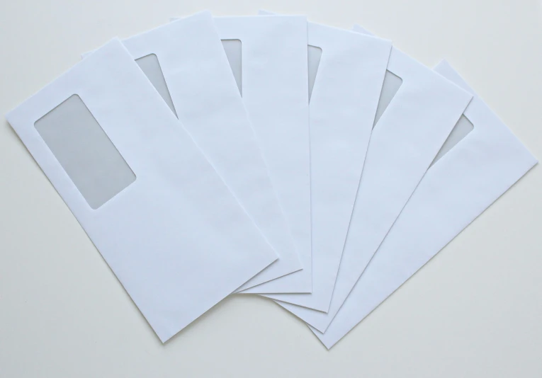 a bunch of white envelopes sitting on top of a table, product image, glass openings, with a white background, multiple stories