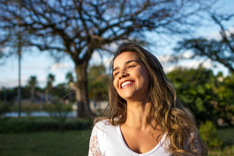 a woman standing in a park with a frisbee in her hand, pexels contest winner, happening, making the best smug smile, in sao paulo, isabela moner, profile image