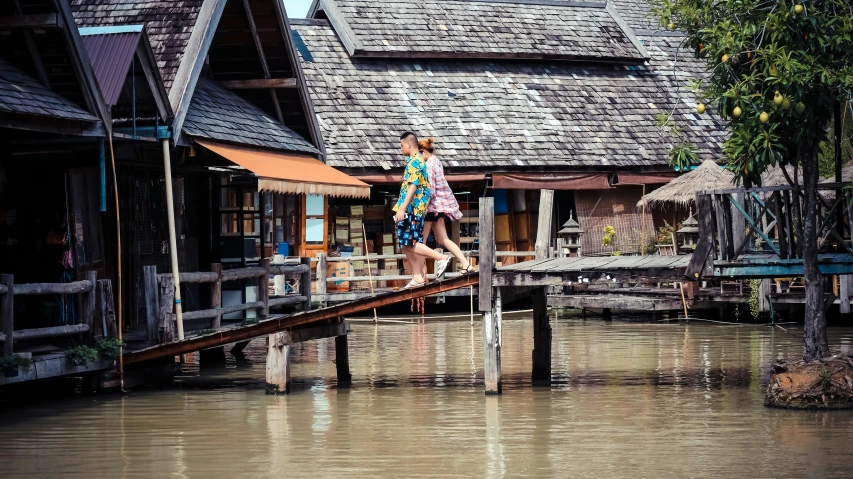 a couple of people that are standing on a bridge, by Peter Churcher, pexels contest winner, renaissance, houses on stilts, thailand, 15081959 21121991 01012000 4k, summer light