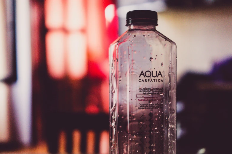 a bottle of water sitting on top of a table, by Julia Pishtar, aqua, promo image, aquapunk, rectangle