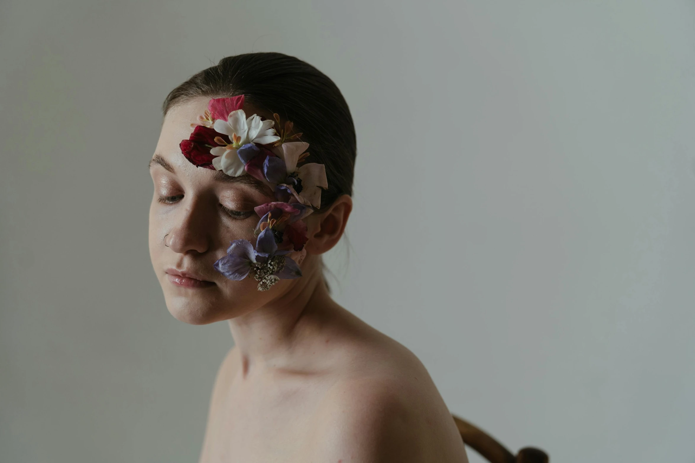 a woman with flowers painted on her face, an album cover, by Fiona Rae, unsplash, hyperrealism, portrait of a ballerina, soft light from the side, organic headpiece, photograph taken in 2 0 2 0