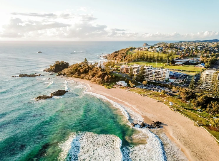 an aerial view of a beach and the ocean, by Lee Loughridge, pexels contest winner, renaissance, bulli, resort, skies behind, notan