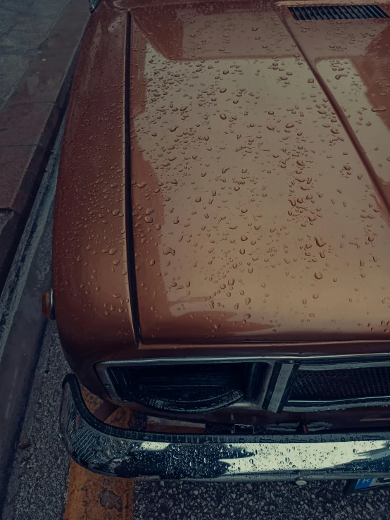 a brown car parked on the side of the road, an album cover, inspired by Elsa Bleda, unsplash contest winner, photorealism, carnal ) wet, high-body detail, high angle close up shot, today\'s featured photograph 4k