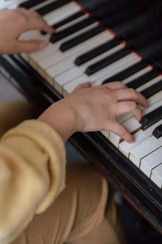 a close up of a person playing a piano, for junior, holding an epée, in a medium full shot, cindy avelino