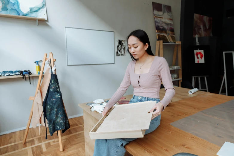 a woman sitting on top of a wooden table, a detailed painting, trending on pexels, carrying a tray, unfinished canvas, asian female, inspect in inventory image