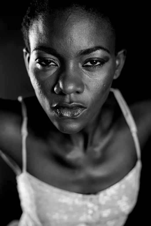 a black and white photo of a woman, inspired by Lee Jeffries, pexels contest winner, hyperrealism, african domme mistress, young angry woman, black skin, pose model