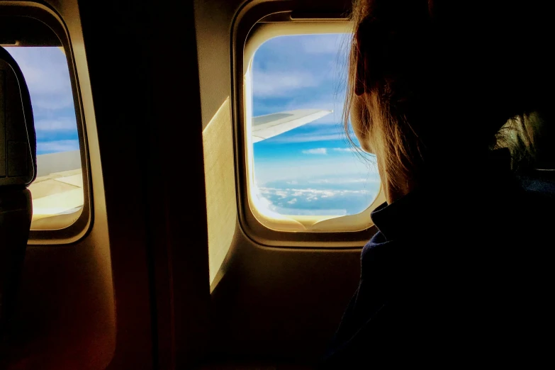 a woman looking out an airplane window at the sky, instagram post, rectangular, blue sky, leaving a room