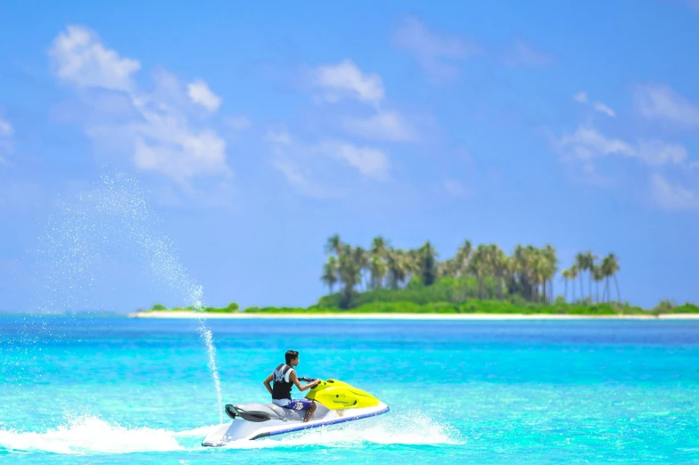 a man riding a jet ski in the ocean, pexels contest winner, hurufiyya, tropical island, light blue water, celebrating, monsoon on tropical island