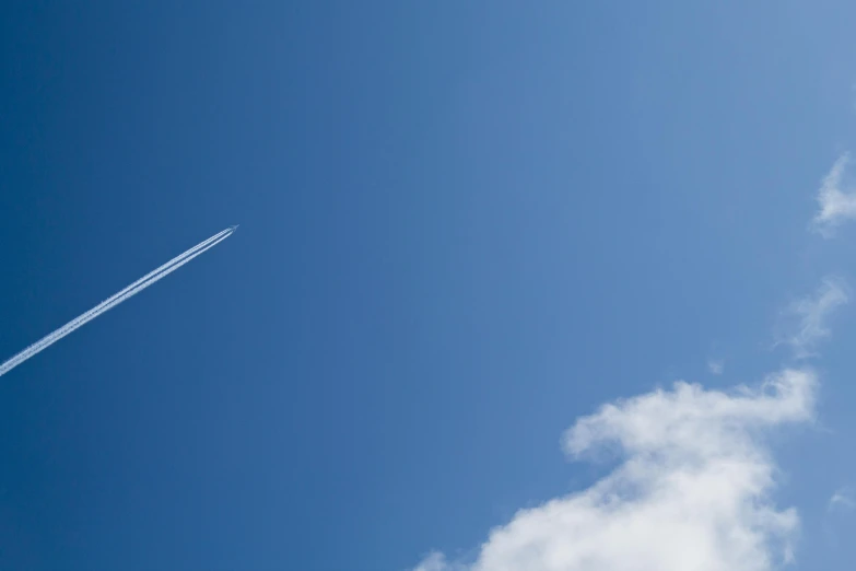 a plane that is flying in the sky, by Julian Allen, minimalism, azure blue sky, fan favorite, contrails, slide show