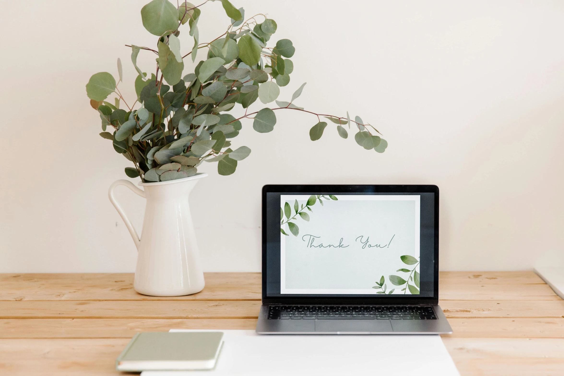 a laptop computer sitting on top of a wooden desk, inspired by Eden Box, trending on unsplash, botanical herbarium paper, thank you, eucalyptus, greeting card