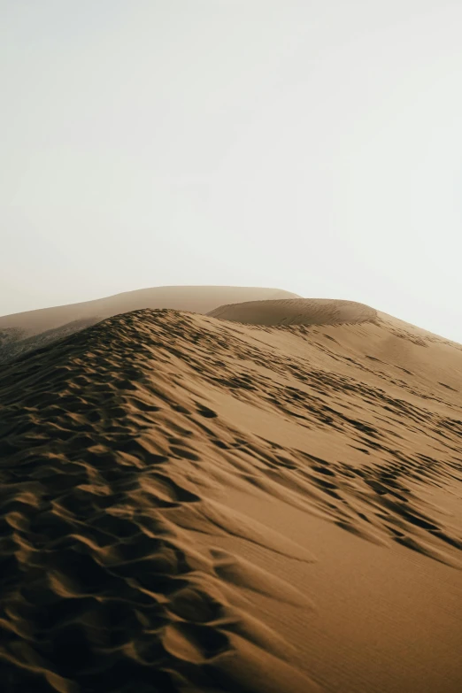 a person standing on top of a sand dune, from afar, insanly detailed, curved, on a canva