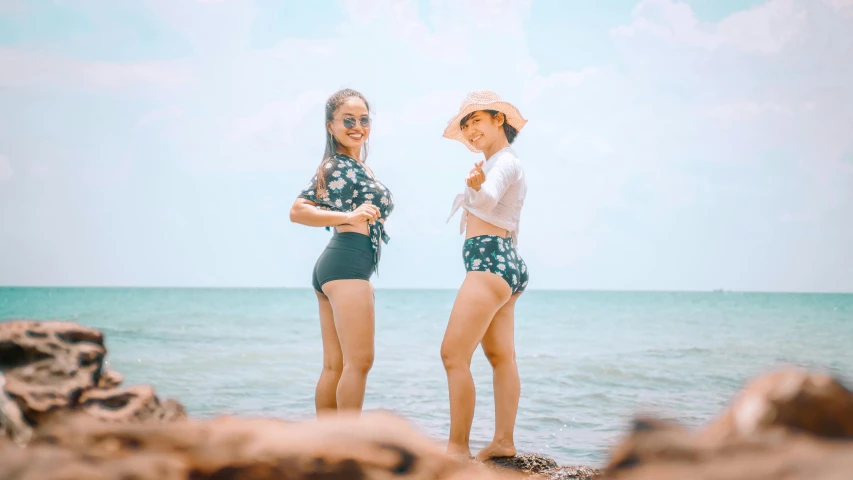 a couple of women standing on top of a beach, in style of lam manh, round thighs, avatar image, cute photo