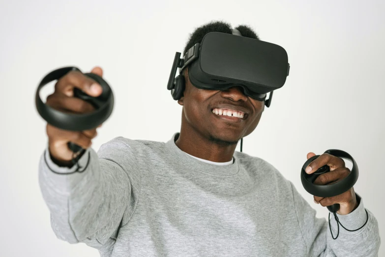 a man holding a pair of video game controllers, inspired by Xanthus Russell Smith, interactive art, floating vr headsets, black teenage boy, press shot, avatar image