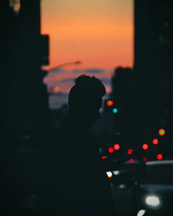 a person standing in the middle of a street at night, an album cover, trending on unsplash, happening, sunset backlight, bisexual lighting, looking to his side, human staring blankly ahead