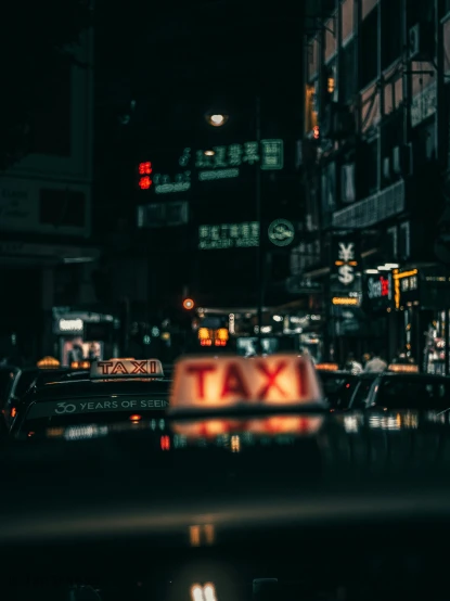 a taxi cab on a city street at night, inspired by Elsa Bleda, pexels contest winner, a still of kowloon, street signs, 🚿🗝📝