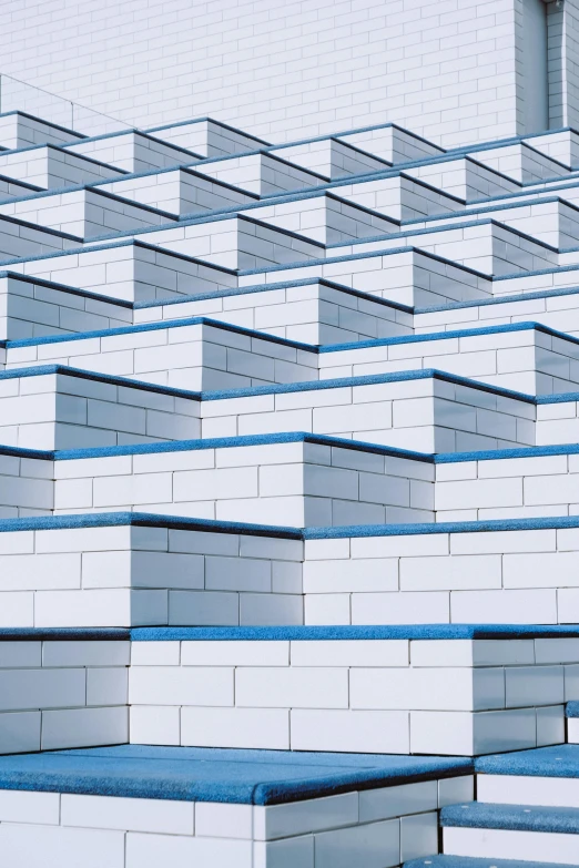 a row of blue and white benches in front of a building, an album cover, inspired by Andreas Gursky, unsplash, op art, building blocks, penrose stairs, hyperdetail, staggered terraces
