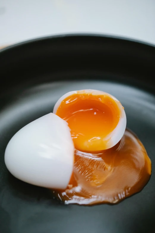 a close up of an egg on a plate, sticky, consistency, drip, evan lee