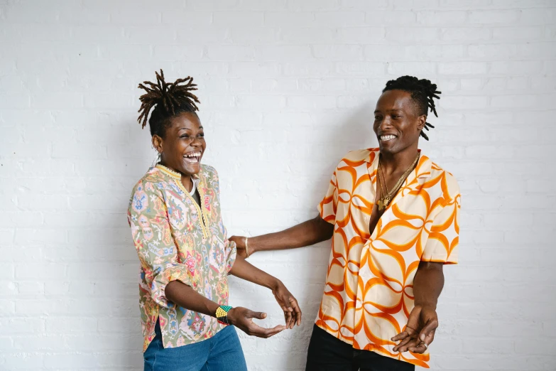 a couple of women standing next to each other, trending on unsplash, black arts movement, earing a shirt laughing, two young men, patterned clothing, reaching out to each other