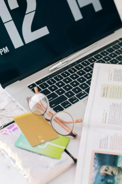 a laptop computer sitting on top of a desk, by Carey Morris, trending on unsplash, private press, 9 9 designs, studious, thumbnail, papers