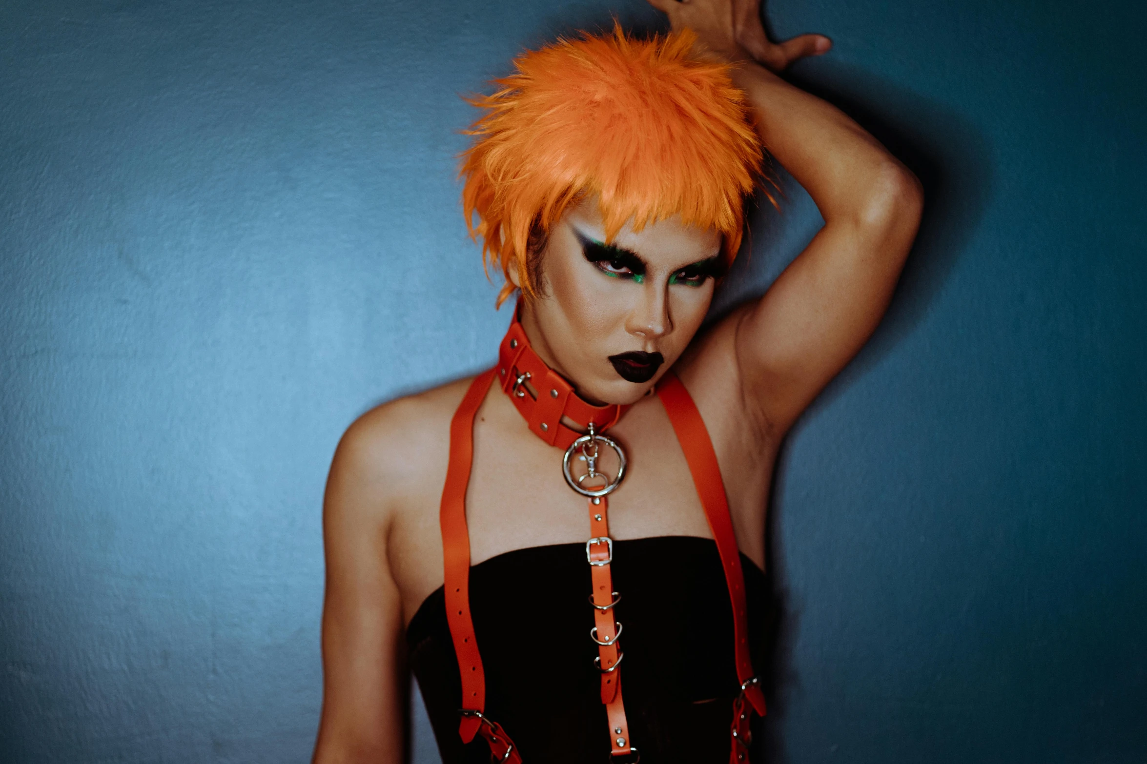 a woman with orange hair posing for a picture, an album cover, inspired by James Bolivar Manson, transgressive art, black leather harness, androgynous male, official store photo, photograph taken in 2 0 2 0