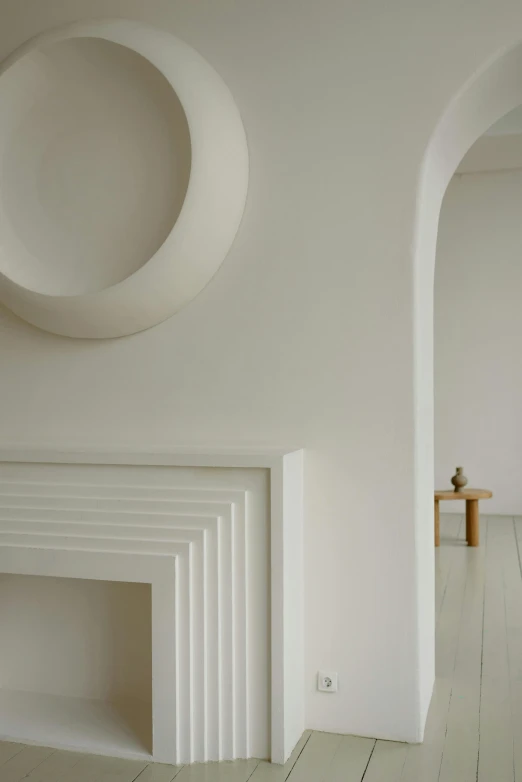 a living room filled with furniture and a fire place, an abstract sculpture, inspired by Rachel Whiteread, unsplash contest winner, light and space, detail shot, white sweeping arches, 1 9 2 0 s minimalism style, recessed