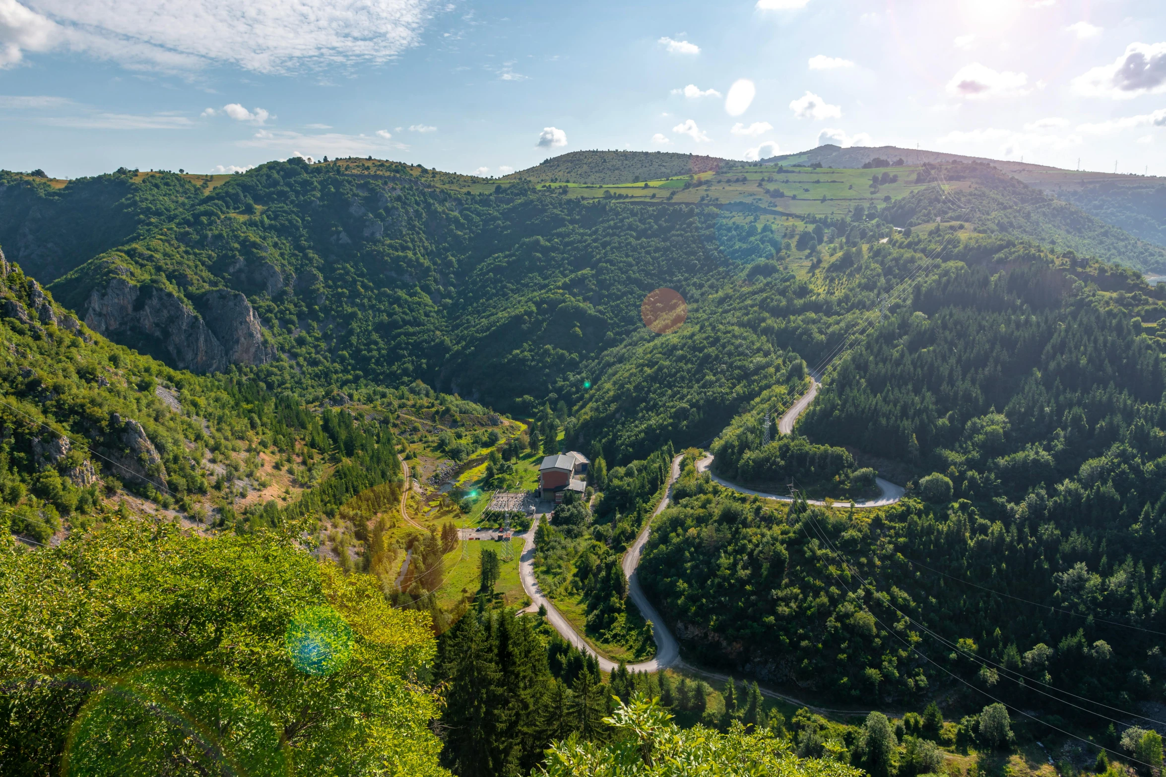 a road winding through a lush green valley, les nabis, photo of džesika devic, exterior shot, overview, thumbnail