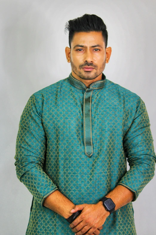 a man standing with his hands in his pockets, inspired by Saurabh Jethani, trending on instagram, hurufiyya, teal tunic, headshot profile picture, brocade robes, thumbnail