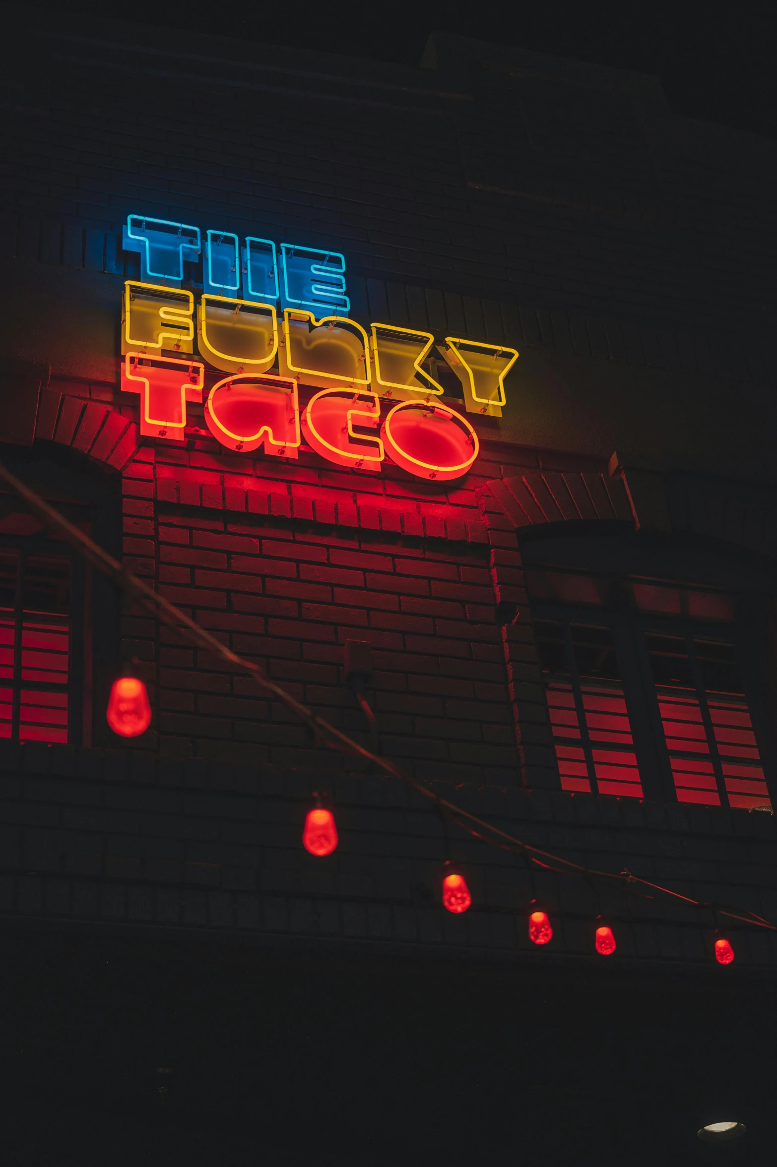 a neon sign on the side of a building, pexels contest winner, funk art, tacos, fancy dress, thumbnail, fancy restaurant