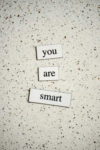 a piece of paper with the words you are smart written on it, pexels, magnetic, ceramic, avatar image, concrete poetry
