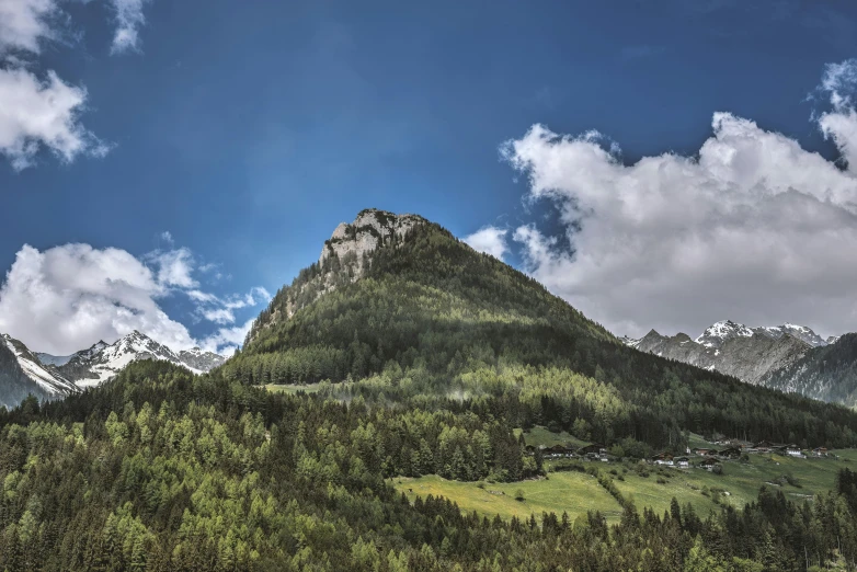 a view of a mountain with a valley in the foreground, by Sebastian Spreng, pexels contest winner, hill with trees, thumbnail, no cropping, view from bottom to top