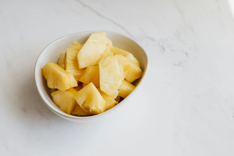 a white bowl filled with chunks of pineapple, unsplash, 🦩🪐🐞👩🏻🦳, angled, pearlized, no crop