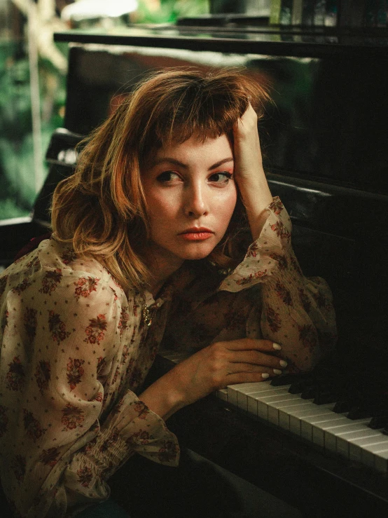 a woman sitting in front of a piano, an album cover, inspired by Elsa Bleda, trending on pexels, photorealism, side portrait of imogen poots, smug look, ilya golitsyn, vintage color