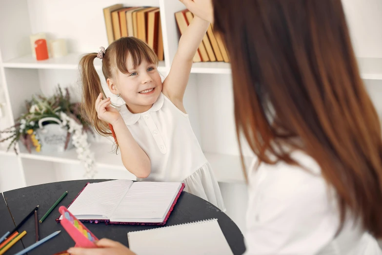 a little girl sitting at a table talking on a cell phone, pexels contest winner, danube school, raising an arm, teacher, 15081959 21121991 01012000 4k, instagram post