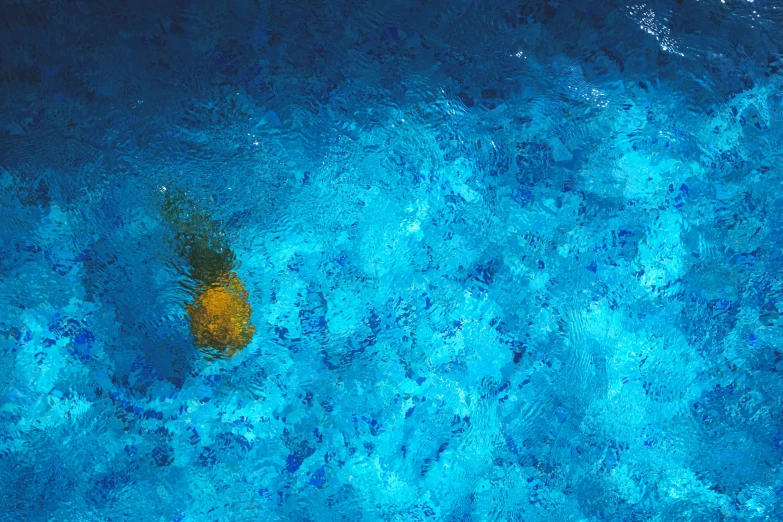 a yellow object floating on top of a blue body of water, pexels contest winner, lyrical abstraction, glass texture, greek pool, goldfish, oil on canvas high angle view