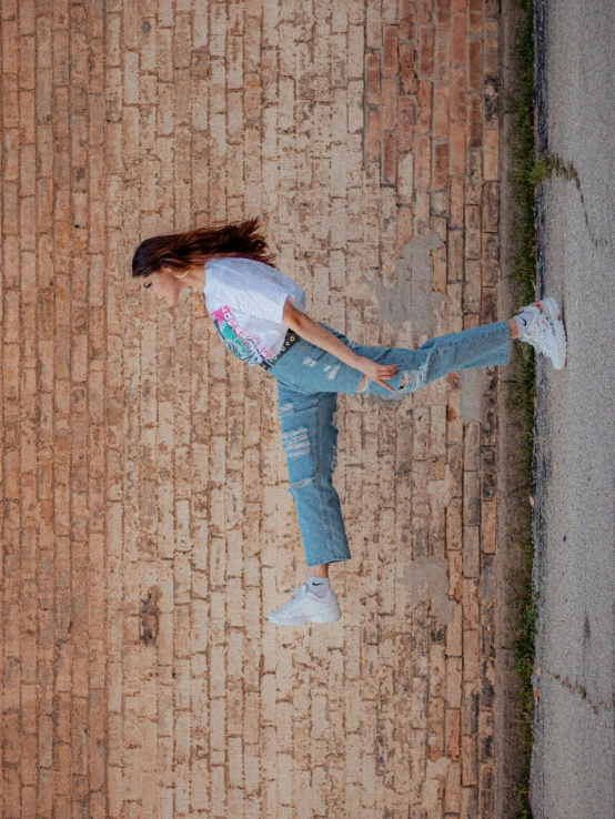 a woman flying through the air while riding a skateboard, inspired by Elsa Bleda, pexels contest winner, happening, jeans and t shirt, bricks flying, view(full body + zoomed out), promotional image