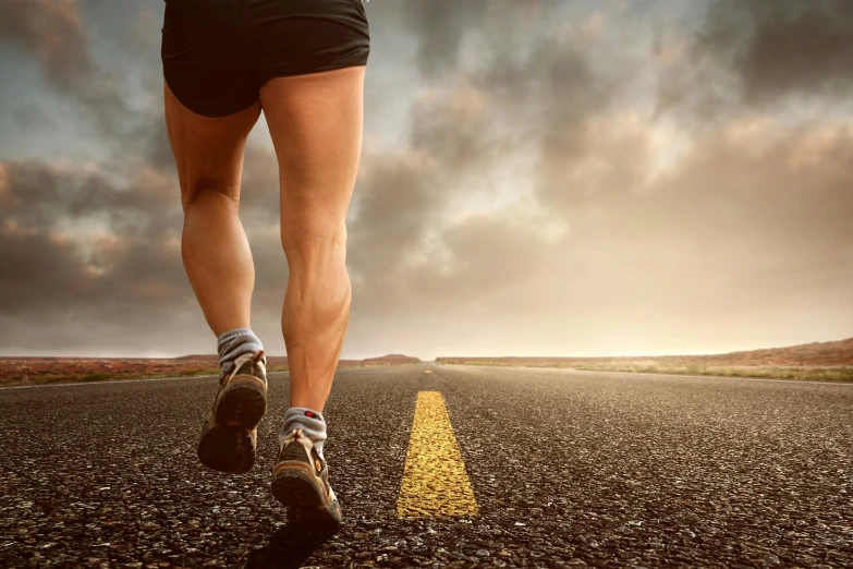 a close up of a person running on a road, by Matt Stewart, shutterstock, muscular thighs, avatar image, gold, philosophy