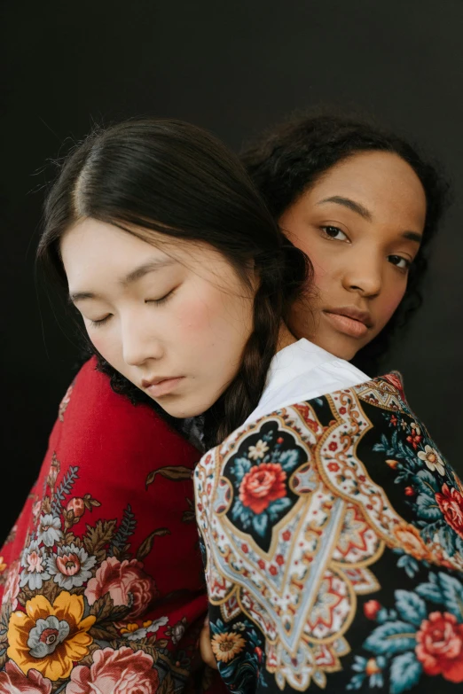 a couple of women standing next to each other, trending on pexels, renaissance, jingna zhang, portrait of women embracing, mixed race woman, patterned clothing