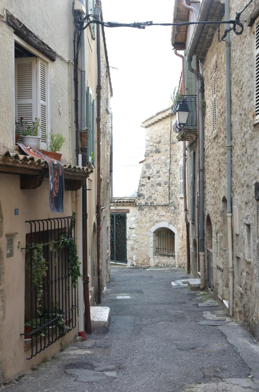 a narrow street is lined with stone buildings, inspired by Carlo Randanini, renaissance, cannes, cottages, view from across the street, well worn