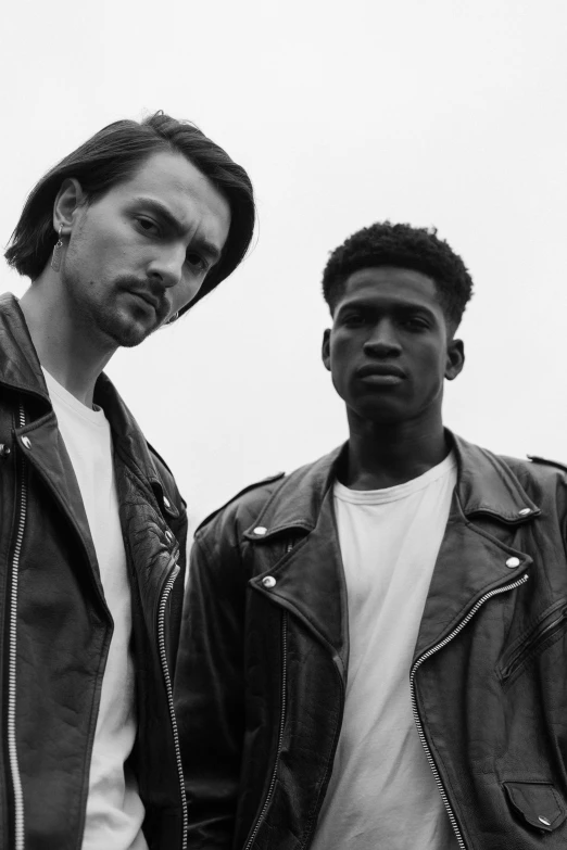 two men in leather jackets standing next to each other, a black and white photo, by Dean Ellis, as fashion editorial 90s, playboi carti, 8 0. lv, group portrait