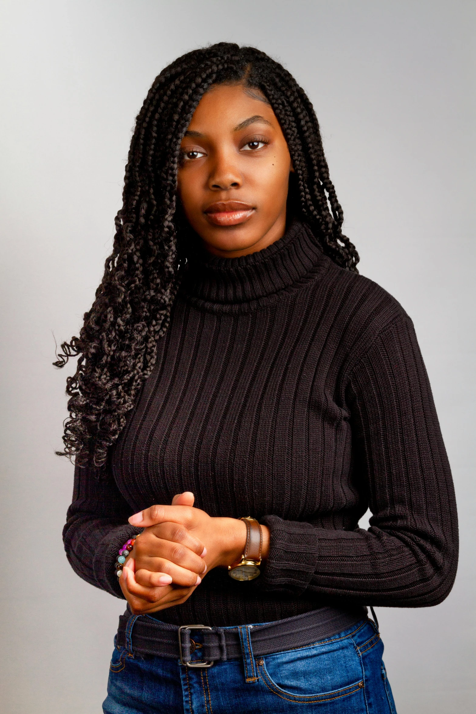 a woman in a black turtle neck sweater and jeans, by Lily Delissa Joseph, pexels contest winner, hurufiyya, professional headshot, ( ( dark skin ) ), panel of black, sza