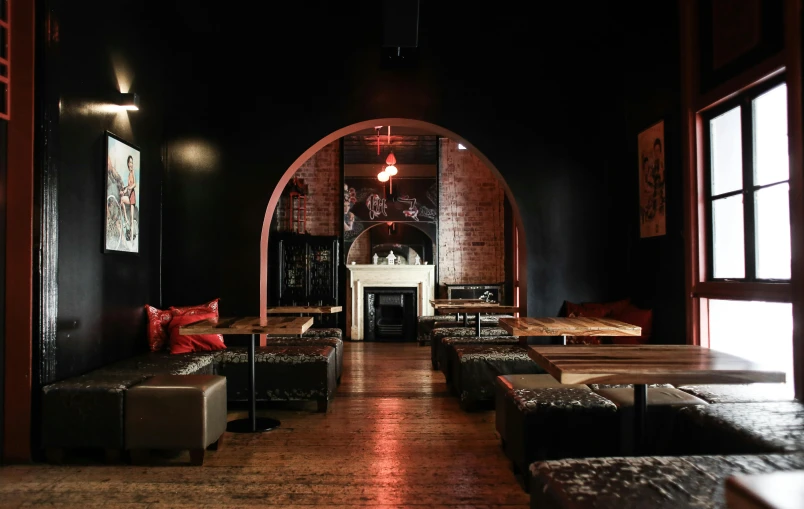 a room filled with lots of couches and tables, unsplash, baroque, chinatown bar, arched doorway, “ iron bark, black and red scheme