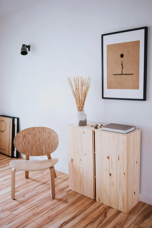 a wooden chair sitting on top of a hard wood floor, inspired by Reinier Nooms, unsplash, light and space, wooden cabinet, apartment of an art student, gallery display photograph, scandinavian