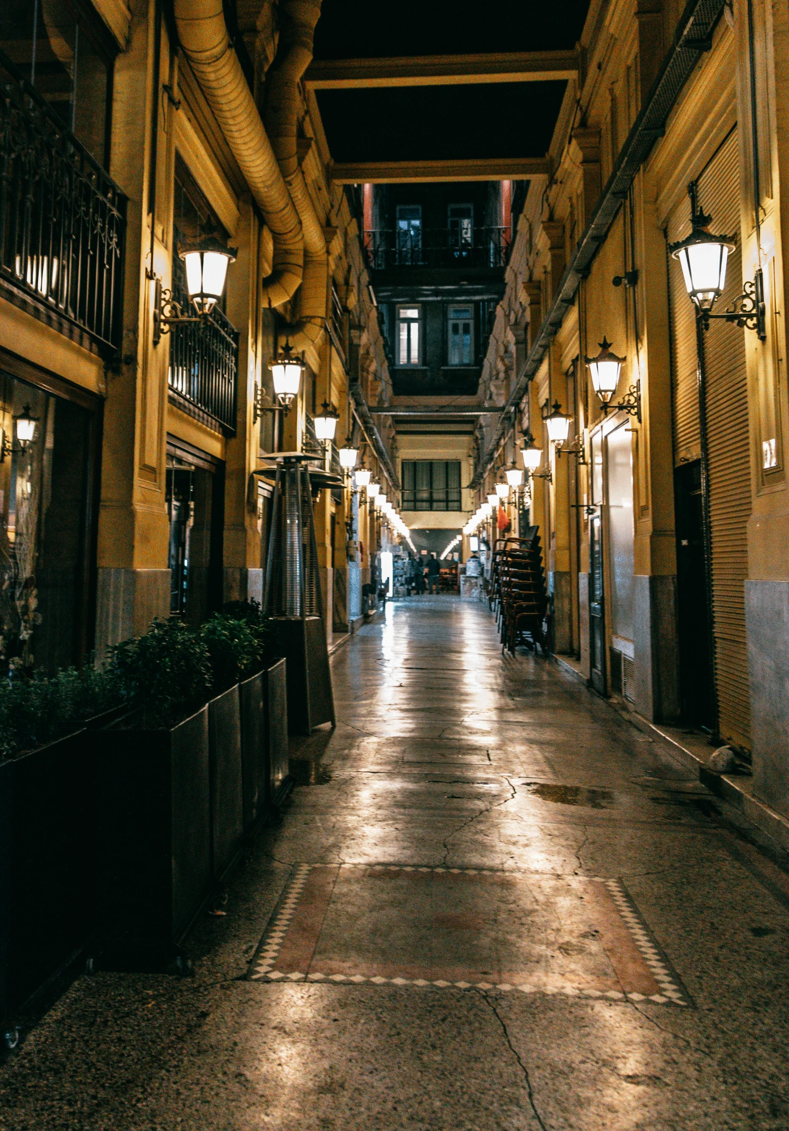 a street filled with lots of lights next to tall buildings, inspired by Tomàs Barceló, unsplash contest winner, 2 5 6 x 2 5 6 pixels, courtyard walkway, old shops, gold