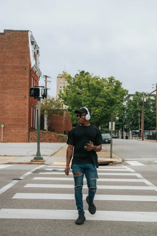 a man walking across a street holding a cell phone, by Carey Morris, trending on unsplash, memphis rap, square, intersection, standing straight